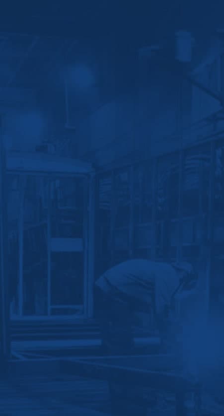 A dark blue tinted background image of two men building trailers.