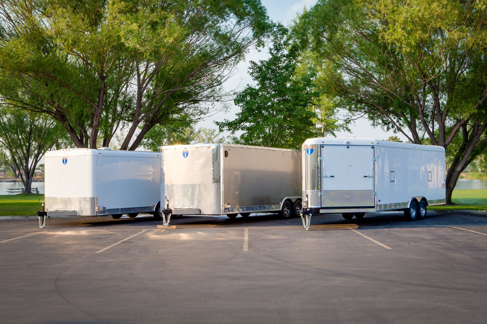 Lineup of white enclosed Interstate trailers in a parking lot