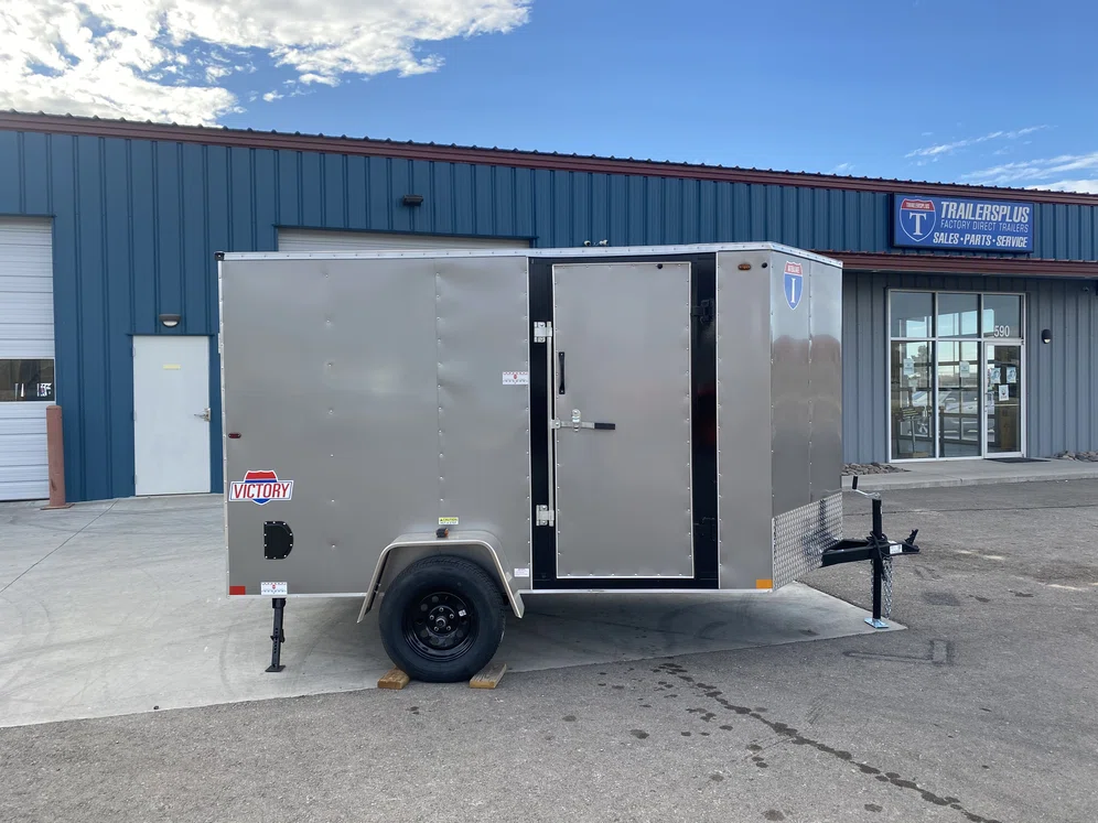 Grey Interstate cargo trailer in TrailersPlus dealership parking lot