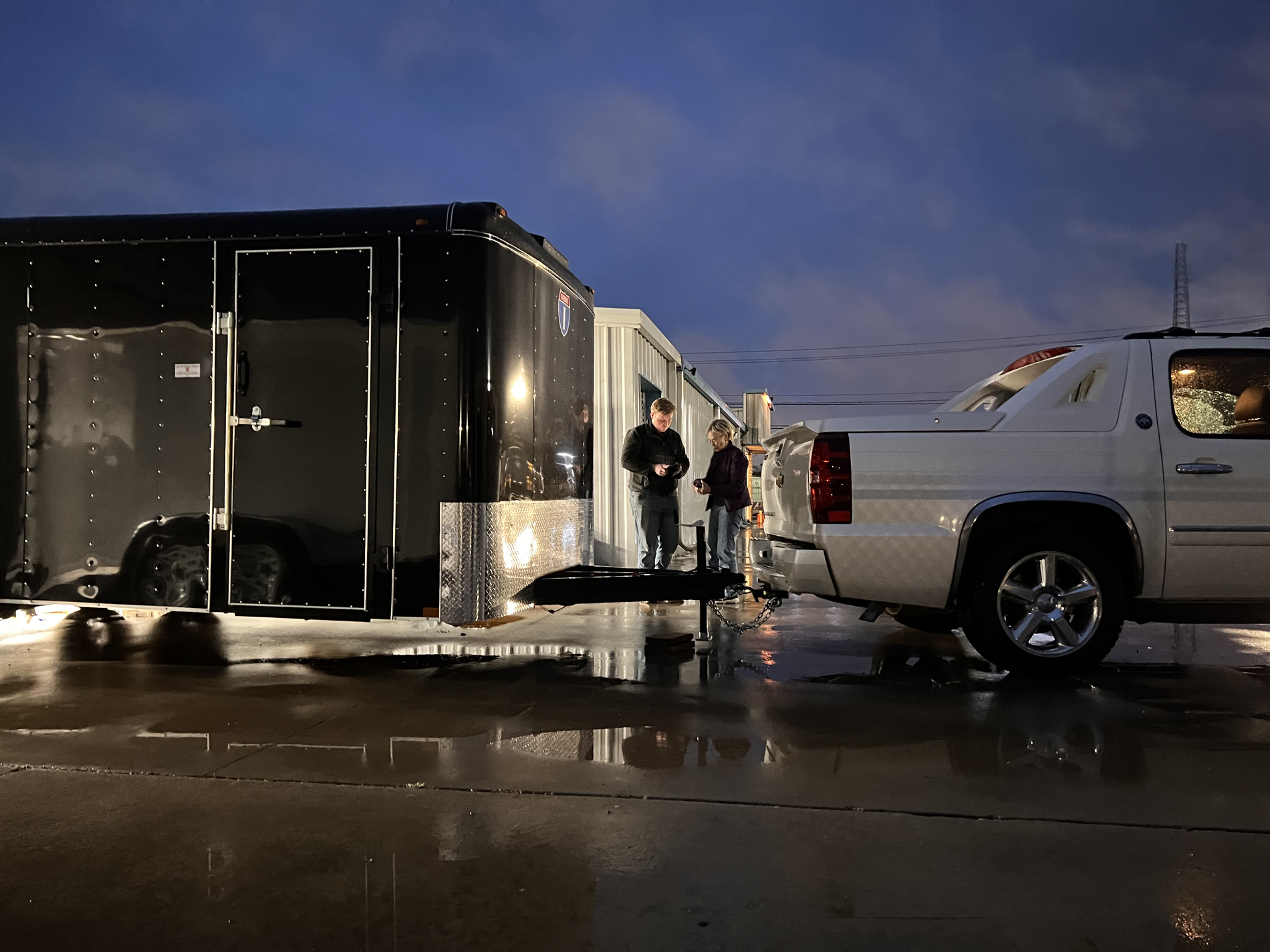 Trailer and truck in parking lot at night