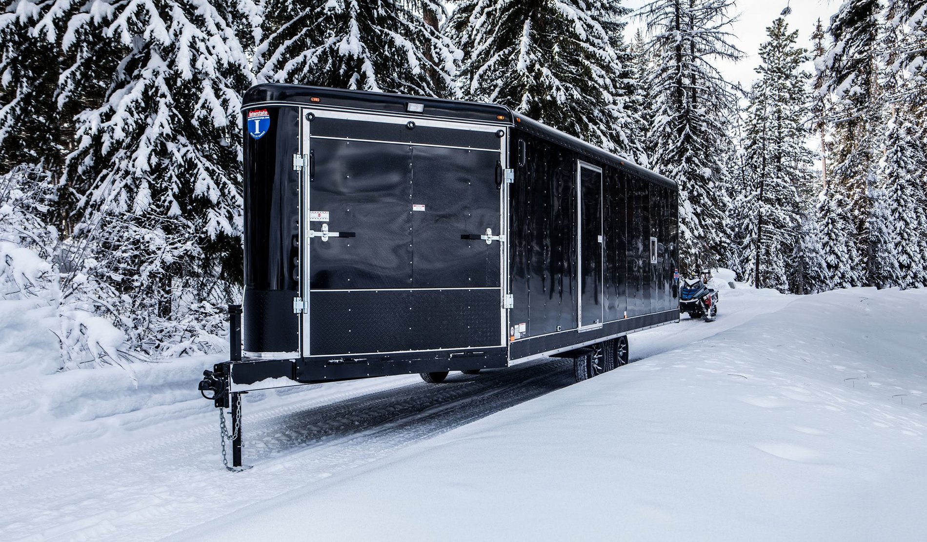 Black ATV trailer in snow