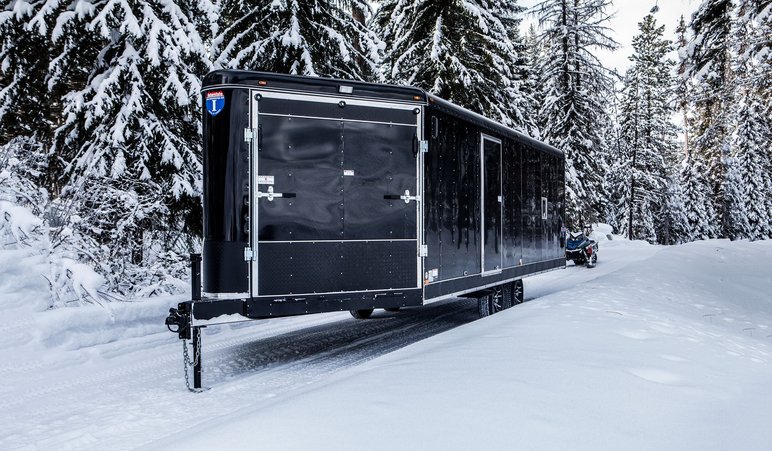 Black ATV trailer in snow