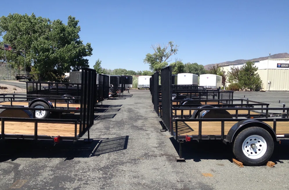Utility trailers lined up in dealership parking lot